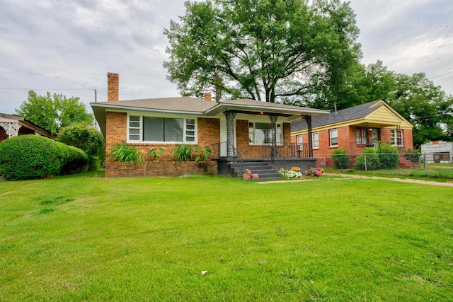 view of front of house with a porch and a front lawn