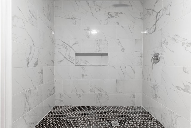 bathroom with a tile shower