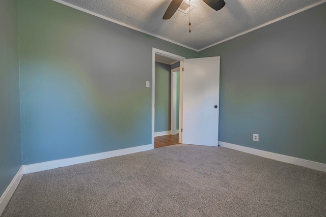 carpeted spare room featuring a textured ceiling and ceiling fan