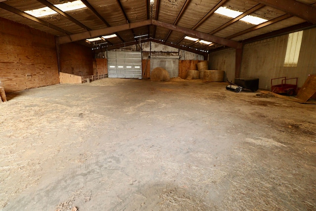 miscellaneous room with concrete flooring and vaulted ceiling