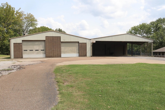 view of front of home featuring a garage, a carport, and a front lawn