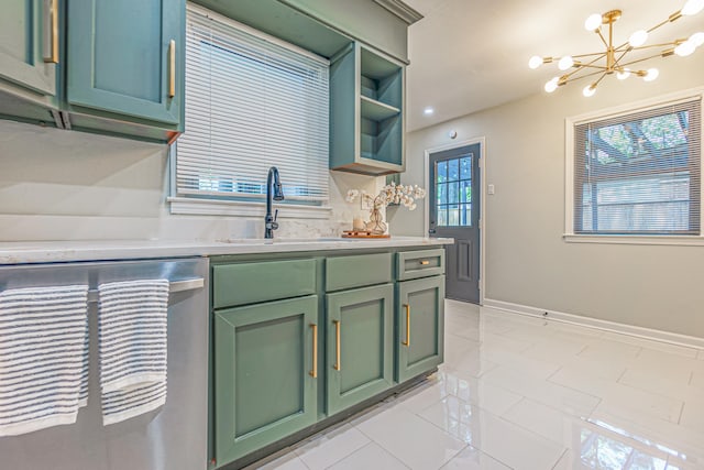 kitchen featuring green cabinetry, a chandelier, sink, pendant lighting, and stainless steel dishwasher