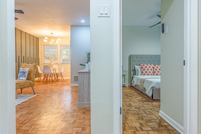 interior space with parquet floors and an inviting chandelier