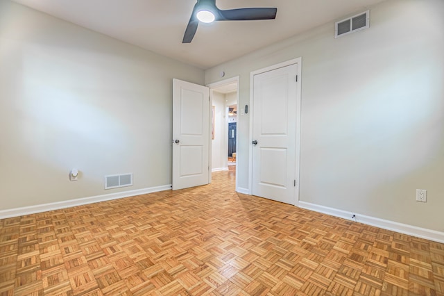 unfurnished room with light parquet floors and ceiling fan