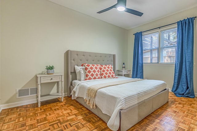 bedroom with ceiling fan and parquet flooring