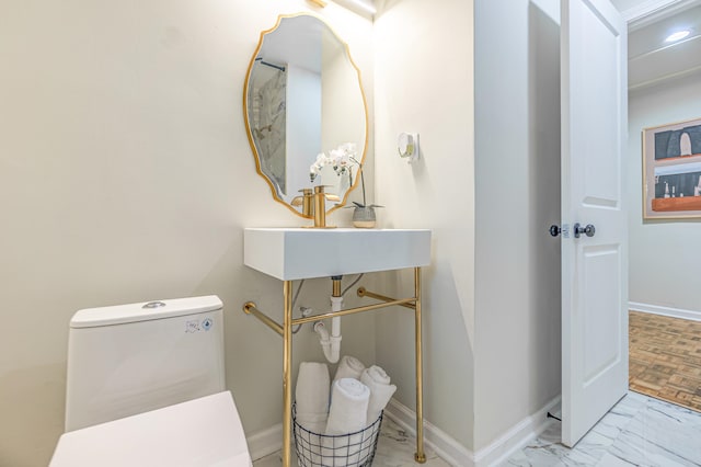 bathroom featuring toilet and sink