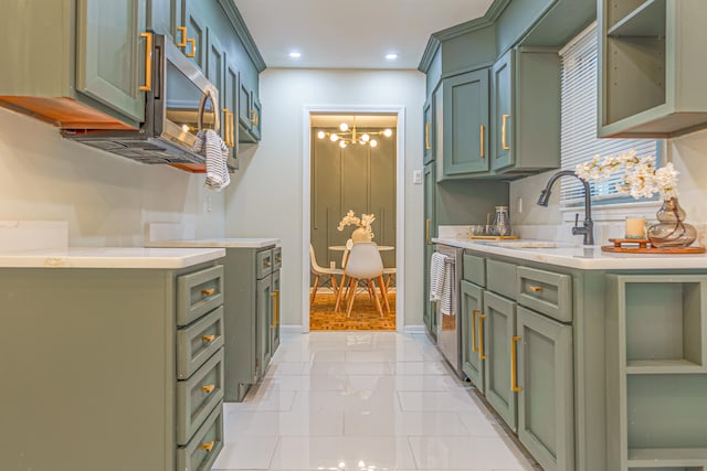 kitchen featuring green cabinetry, sink, and an inviting chandelier