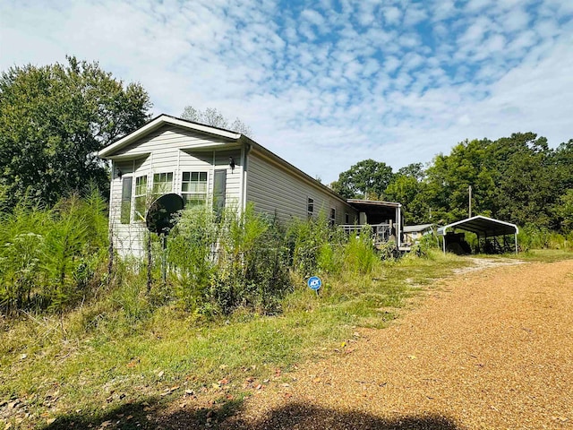 view of side of home with a carport