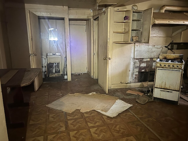 kitchen with white range with gas stovetop and dark parquet flooring