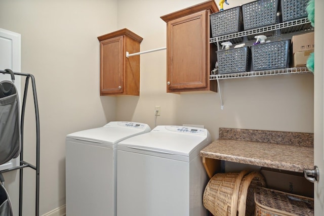 washroom with cabinets and washer and clothes dryer