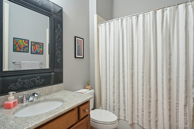 bathroom featuring vanity, toilet, and a shower with curtain