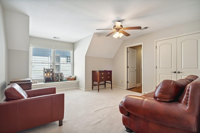 carpeted living room with ceiling fan