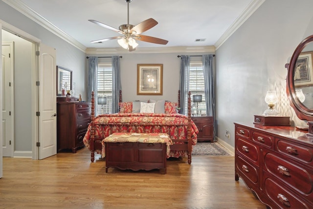 bedroom featuring ceiling fan, light hardwood / wood-style floors, and ornamental molding