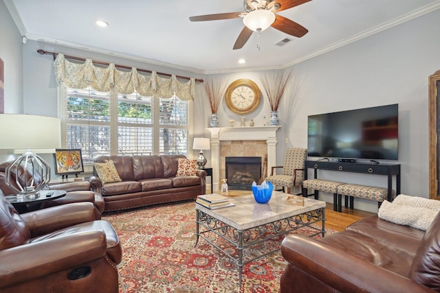 living room featuring ceiling fan, ornamental molding, and hardwood / wood-style floors