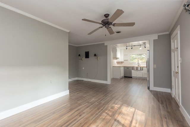 unfurnished living room featuring rail lighting, ceiling fan, hardwood / wood-style flooring, and ornamental molding