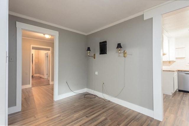 spare room with crown molding and light hardwood / wood-style flooring