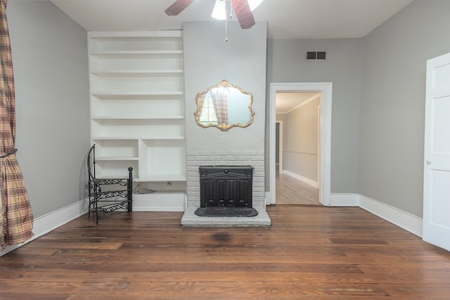 unfurnished living room featuring ceiling fan, dark hardwood / wood-style floors, and a fireplace