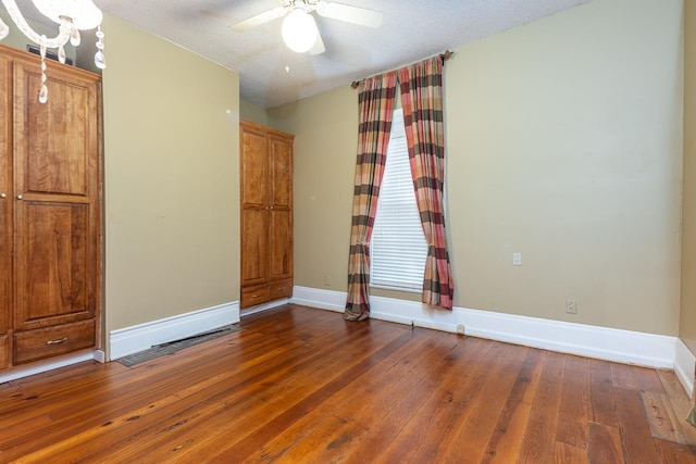 spare room with a textured ceiling, wood-type flooring, and ceiling fan