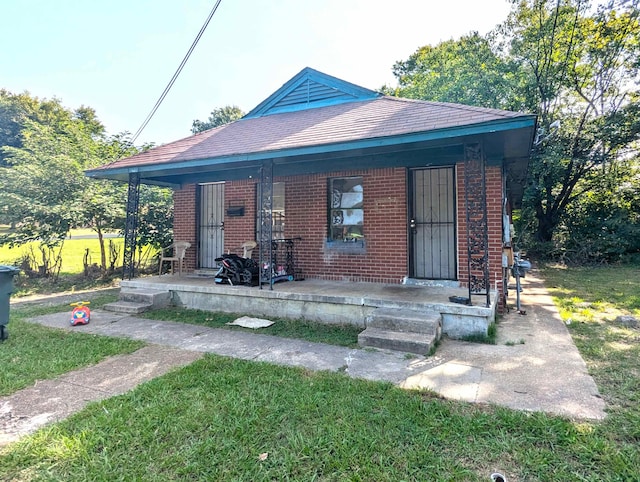 bungalow-style house with covered porch and a front yard