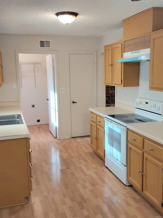 kitchen featuring light brown cabinets, light hardwood / wood-style flooring, a textured ceiling, and white electric range oven