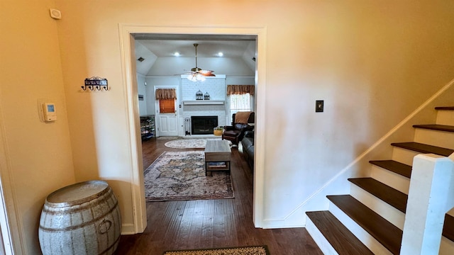 hall featuring lofted ceiling and dark hardwood / wood-style flooring