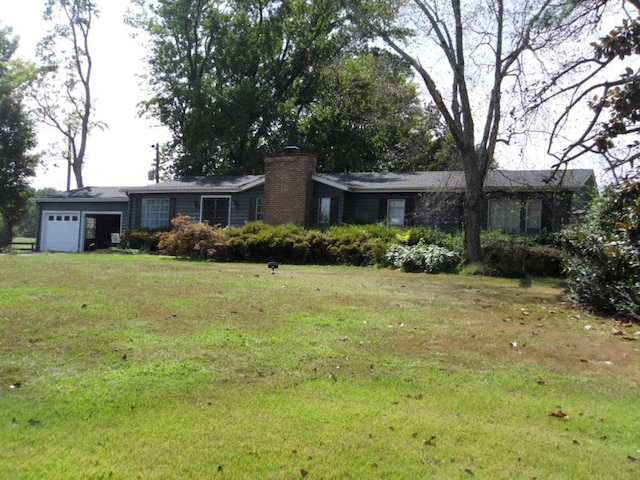 ranch-style home featuring a garage and a front lawn