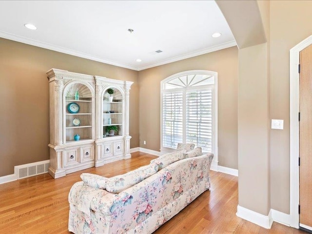 interior space featuring ornamental molding and light hardwood / wood-style flooring