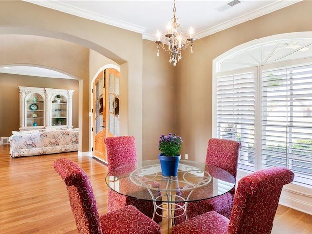 dining room featuring hardwood / wood-style floors, a chandelier, and a healthy amount of sunlight