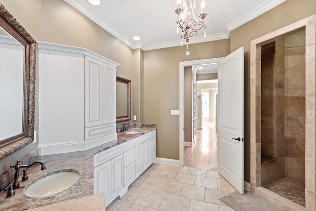 bathroom with crown molding, vanity, and tiled shower