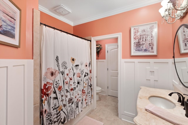 bathroom with vanity, toilet, ornamental molding, and a shower with shower curtain