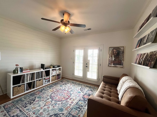 sitting room with ceiling fan, hardwood / wood-style floors, and french doors