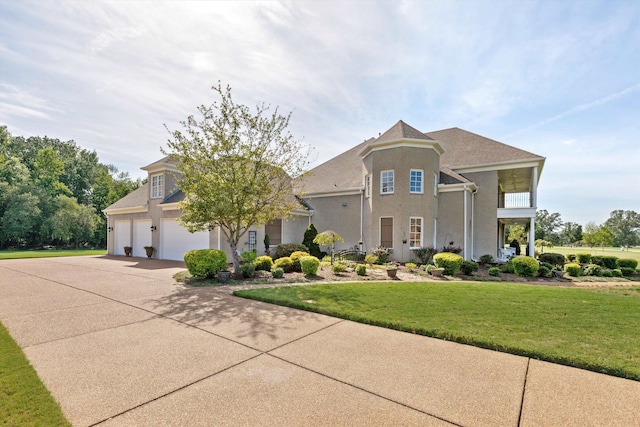 view of front of property with a front yard and a garage