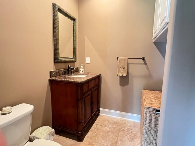 bathroom featuring vanity, toilet, and tile patterned floors