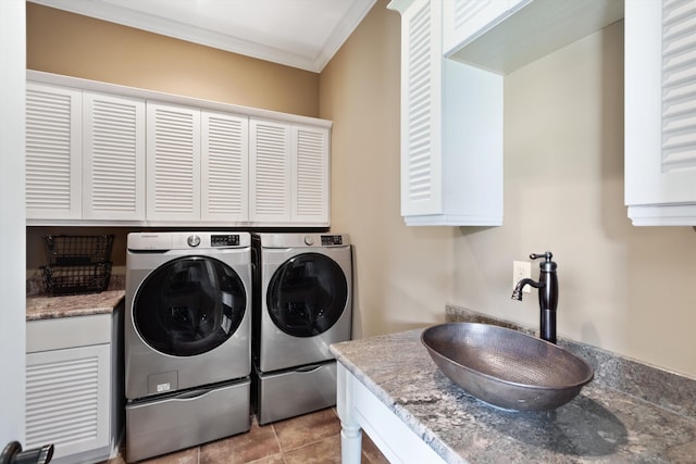 laundry room featuring cabinets, crown molding, light tile patterned floors, washer and dryer, and sink