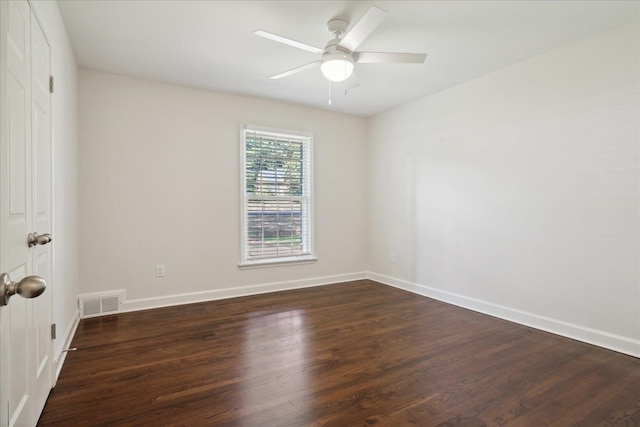 empty room with dark hardwood / wood-style flooring and ceiling fan