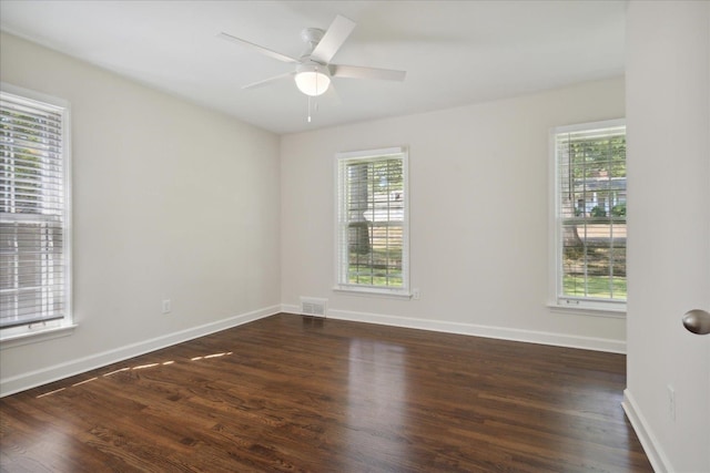 unfurnished room featuring dark wood-type flooring and ceiling fan