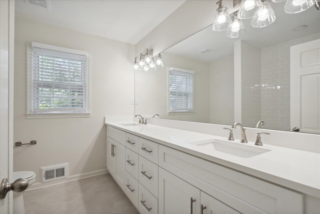 bathroom featuring vanity, toilet, a notable chandelier, and walk in shower