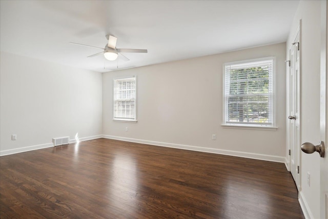 spare room featuring dark hardwood / wood-style flooring and ceiling fan