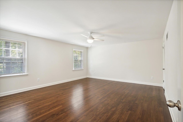 unfurnished room with dark hardwood / wood-style flooring and ceiling fan