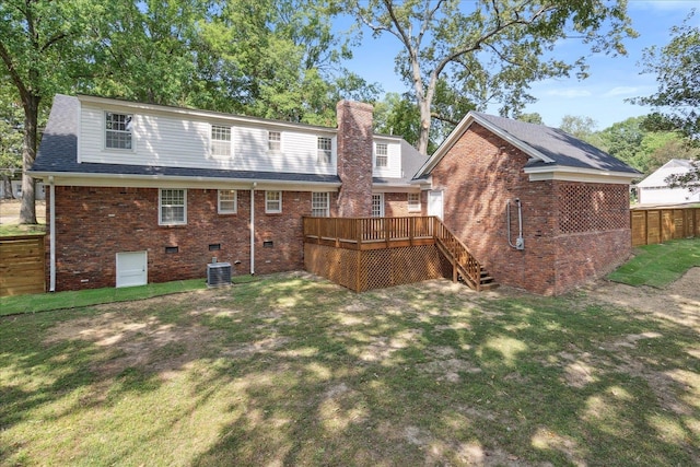 back of house with central AC, a wooden deck, and a lawn