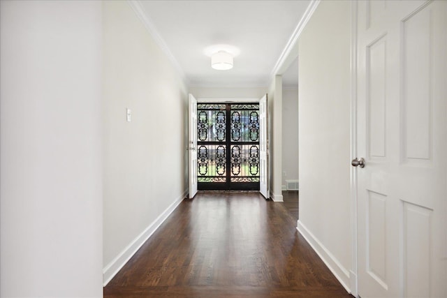 hallway with dark hardwood / wood-style floors and crown molding