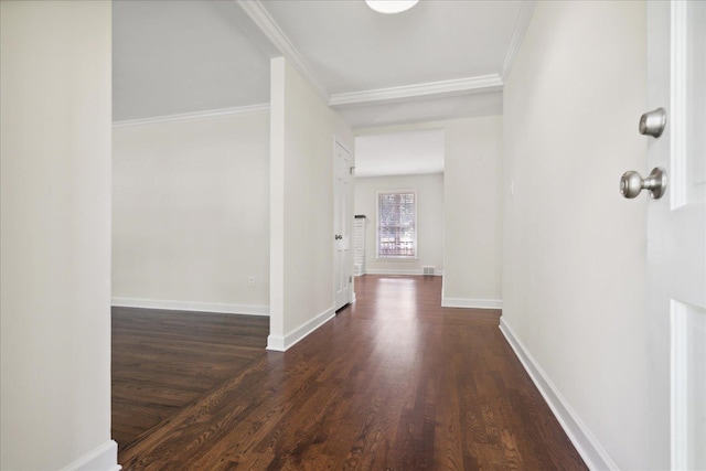 corridor featuring ornamental molding and dark hardwood / wood-style floors