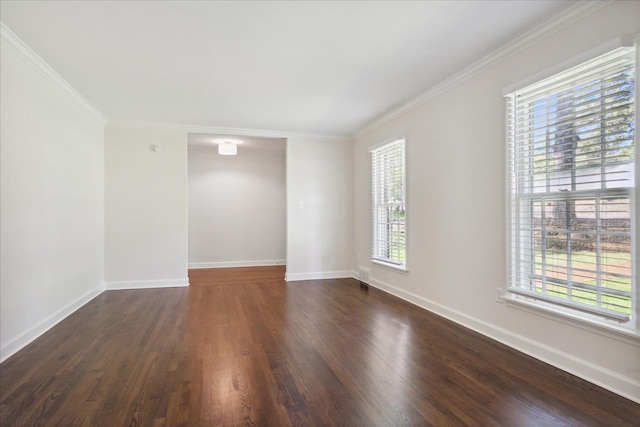 empty room featuring crown molding, a healthy amount of sunlight, and dark hardwood / wood-style floors