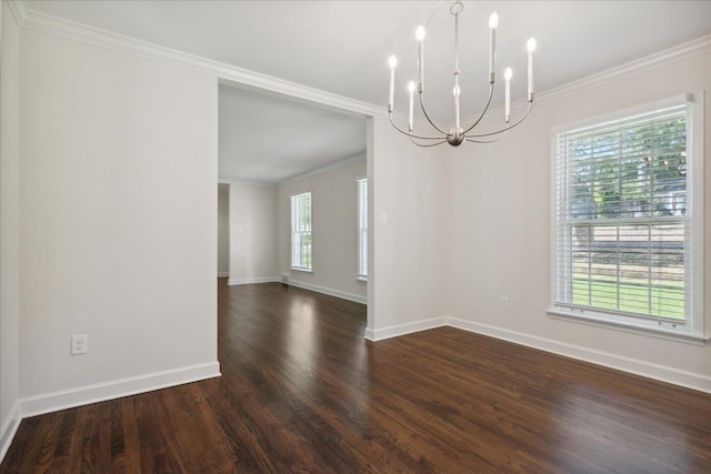 spare room featuring crown molding, dark hardwood / wood-style floors, and a notable chandelier