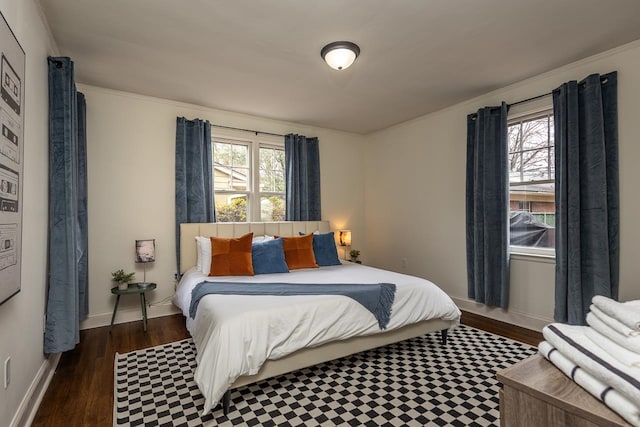 bedroom featuring ornamental molding and dark hardwood / wood-style flooring