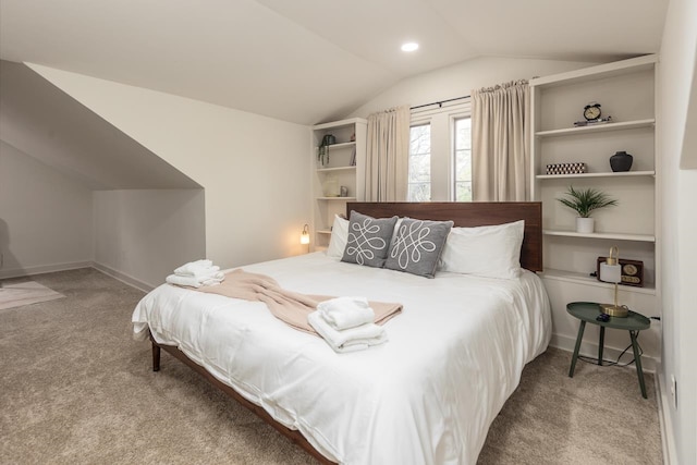 carpeted bedroom with lofted ceiling