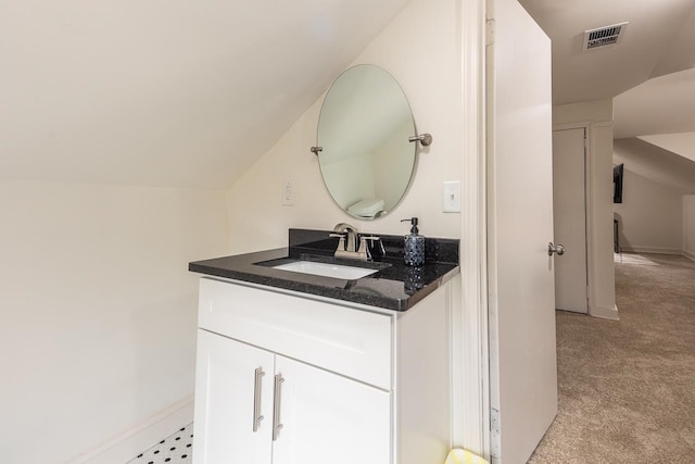 bathroom with vanity and vaulted ceiling