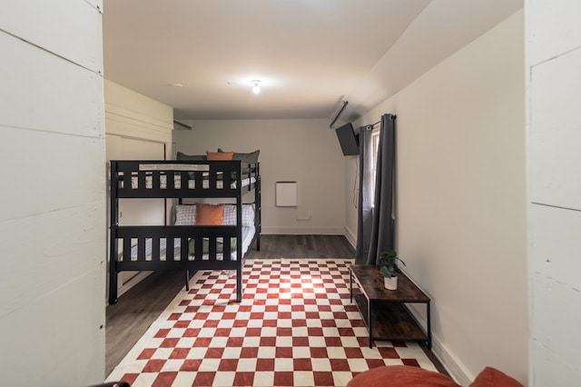 bedroom with dark hardwood / wood-style floors