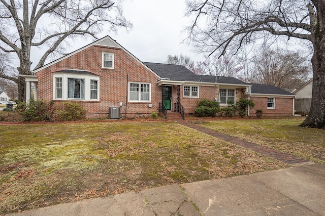 view of front of home with a front yard and central AC unit