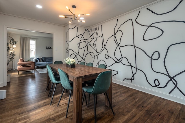 dining space with dark hardwood / wood-style floors, an inviting chandelier, and ornamental molding